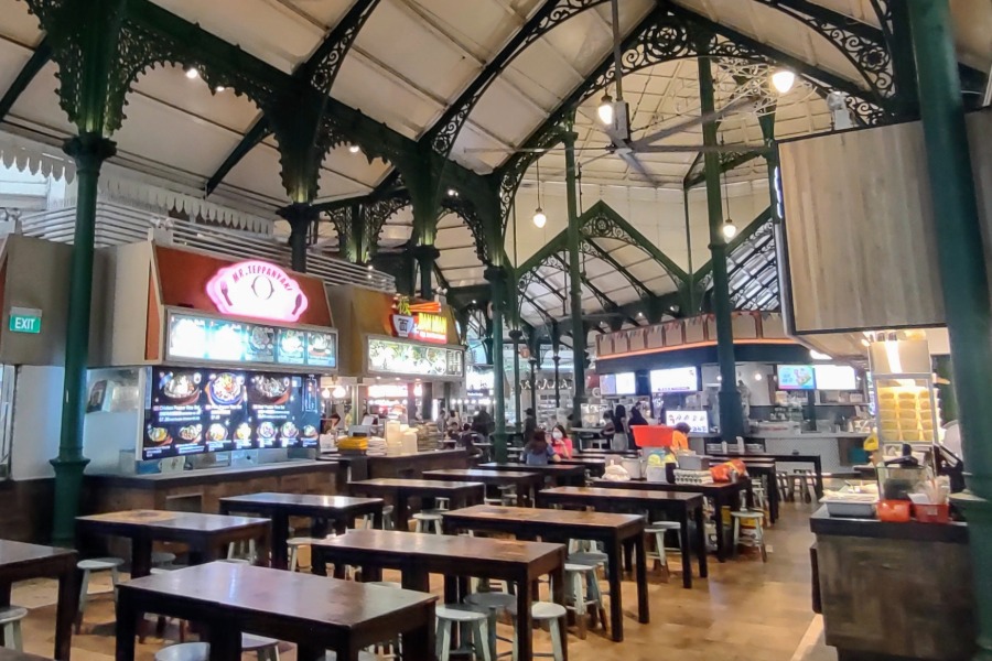 Street food hawker centre in singapore. Tables, chairs and street food stands.