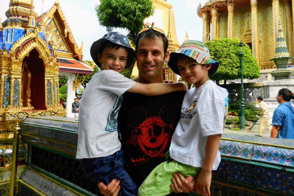 Southeast Asia, children and their father in a beautiful temple
